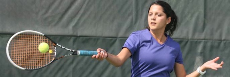 Woman tennis player playing a forehand during an individual tennis lesson in the tennis camp of the val d'allos